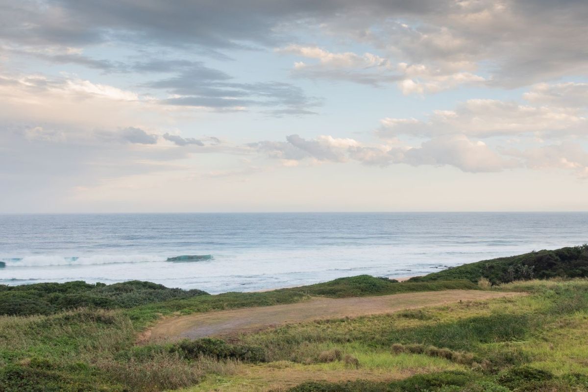 A scenic view of the ocean and coastal landscape, showcasing the natural beauty and potential of this vacant residential land.