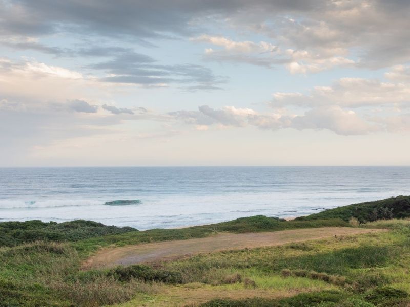 A scenic view of the ocean and coastal landscape, showcasing the natural beauty and potential of this vacant residential land.