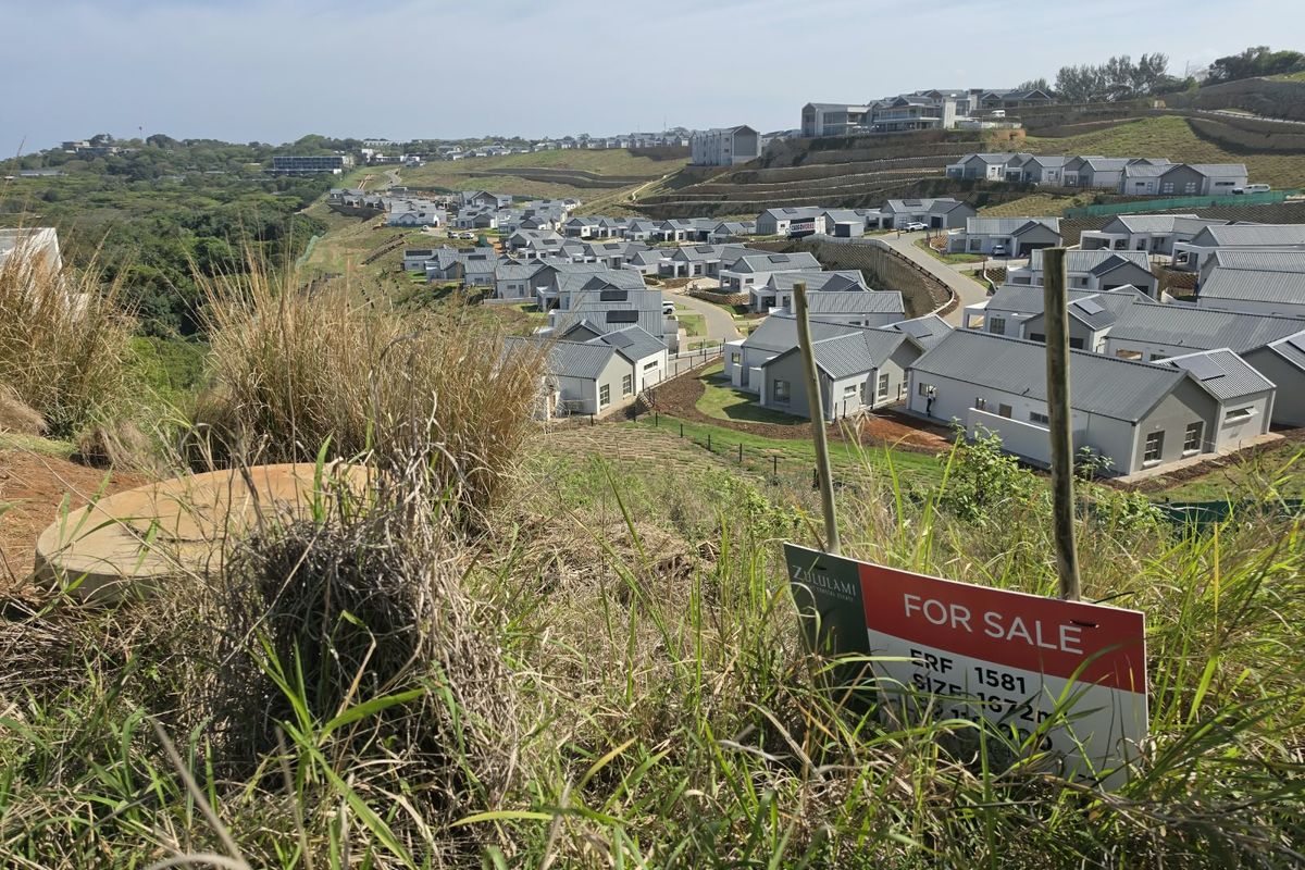 Elevated view overlooking a residential estate development with a for sale sign in the foreground.