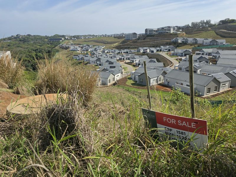 Elevated view overlooking a residential estate development with a for sale sign in the foreground.