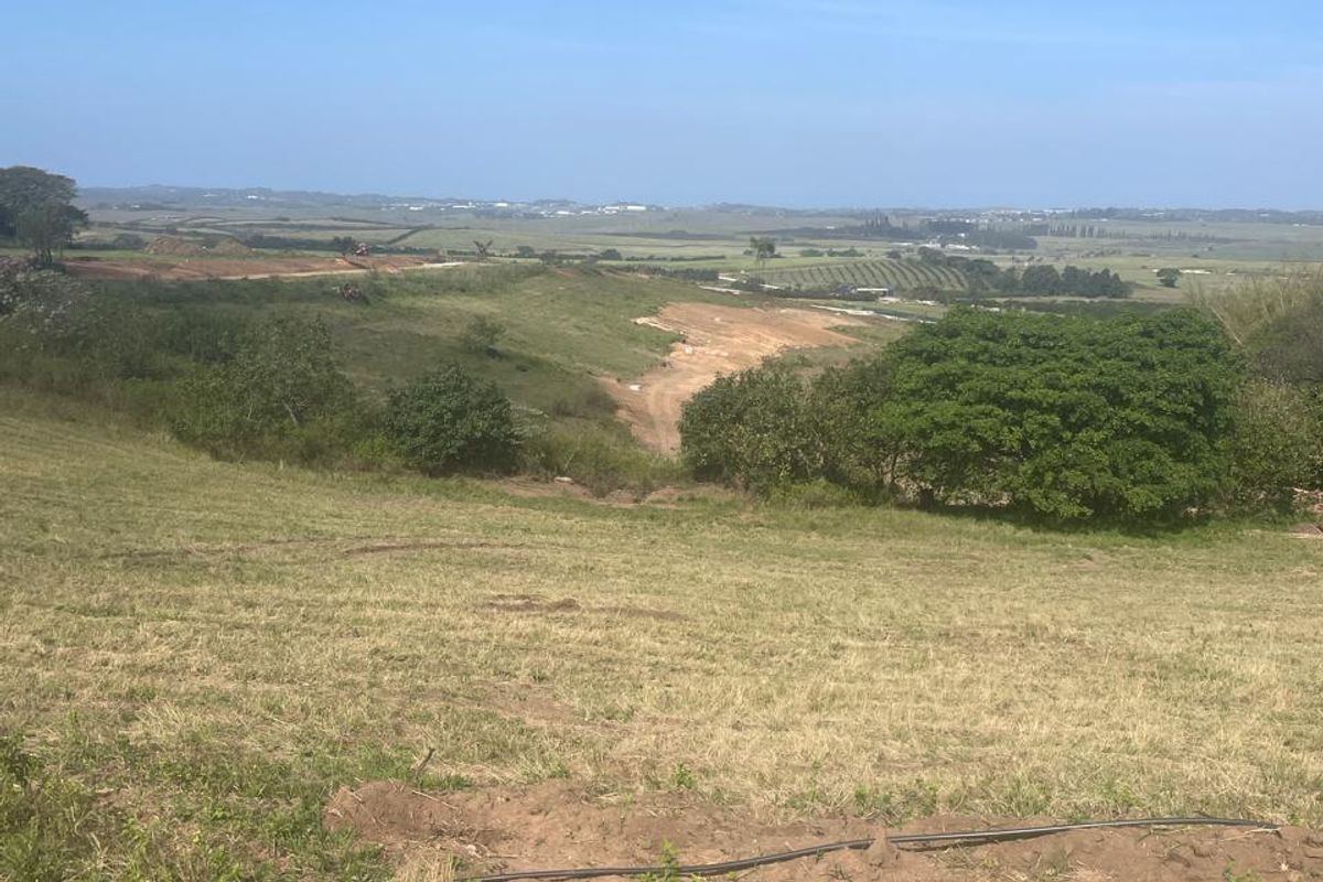 A wide-angle view of the vacant residential land, showcasing the natural landscape and surrounding terrain.