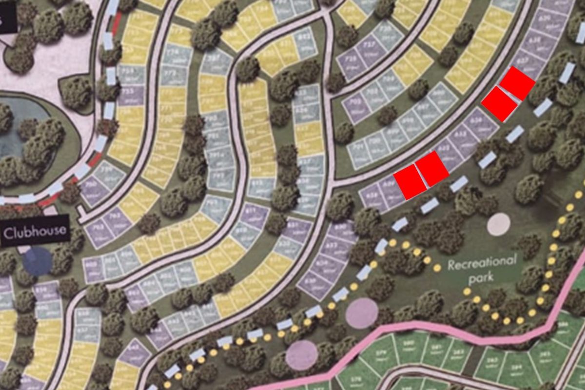 A site development plan showing the layout of residential plots, roads, and recreational areas within the estate.