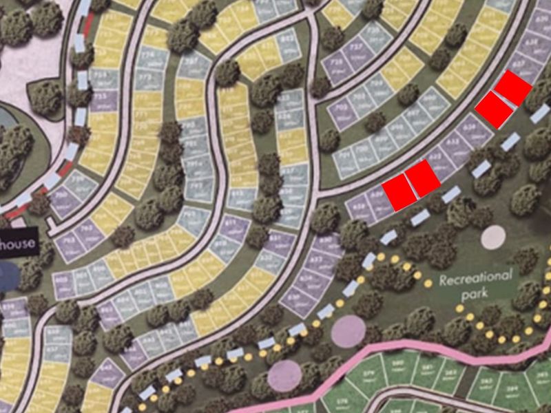 A site development plan showing the layout of residential plots, roads, and recreational areas within the estate.