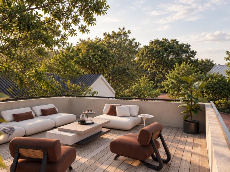A spacious elevated balcony featuring timber decking and a metal balustrade, offering a peaceful outdoor seating area with views of surrounding trees.
