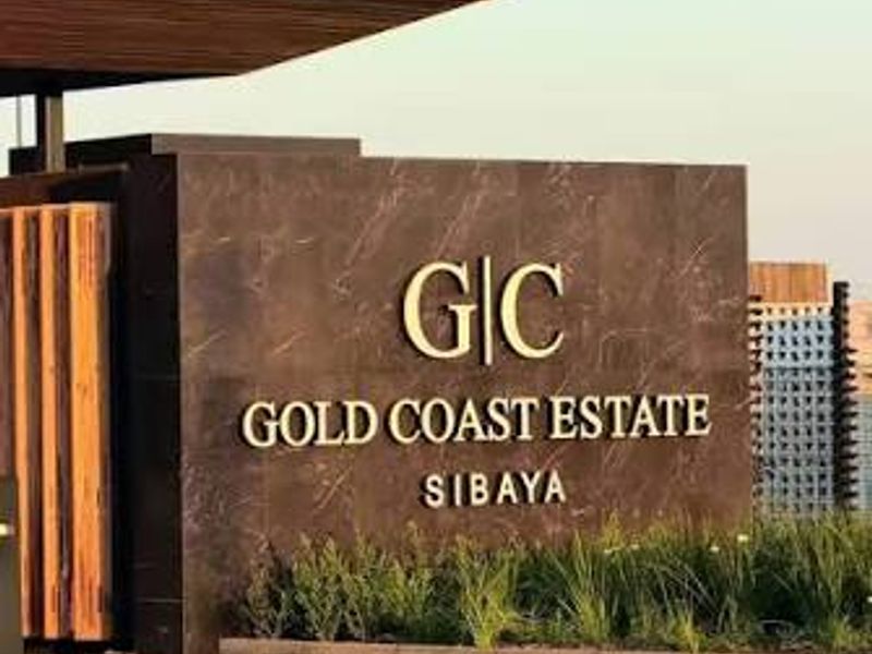 The entrance to Gold Coast Estate in Sibaya, featuring a modern stone-clad signage wall, architectural canopy, and well-maintained landscaped surroundings.