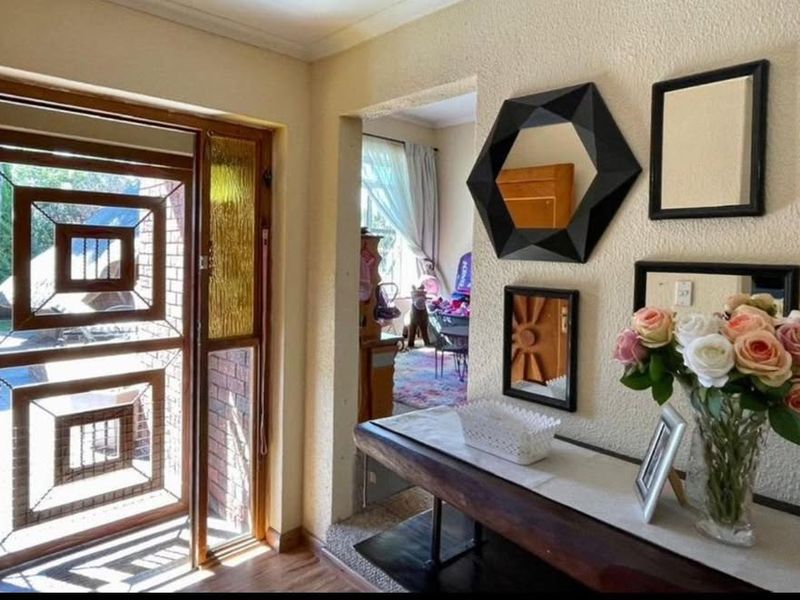 Entrance area featuring a decorative security gate and textured wall finishes, providing a welcoming transition into the home.