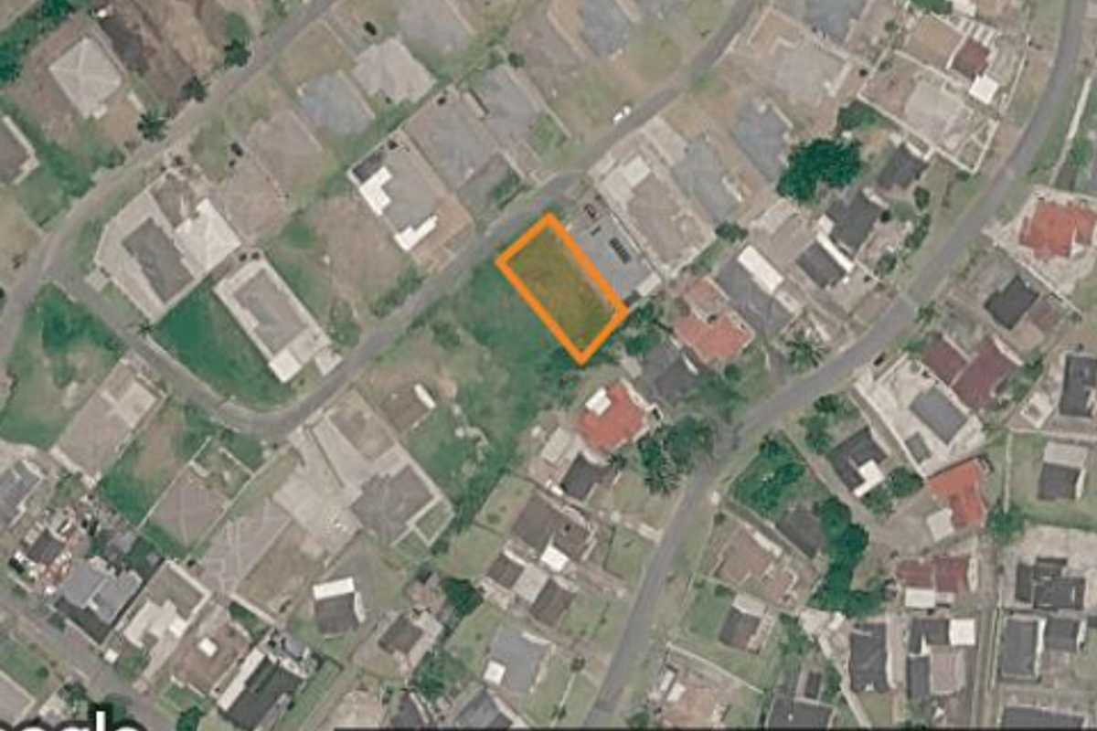 Aerial view of a vacant residential plot situated within an established suburban neighborhood.