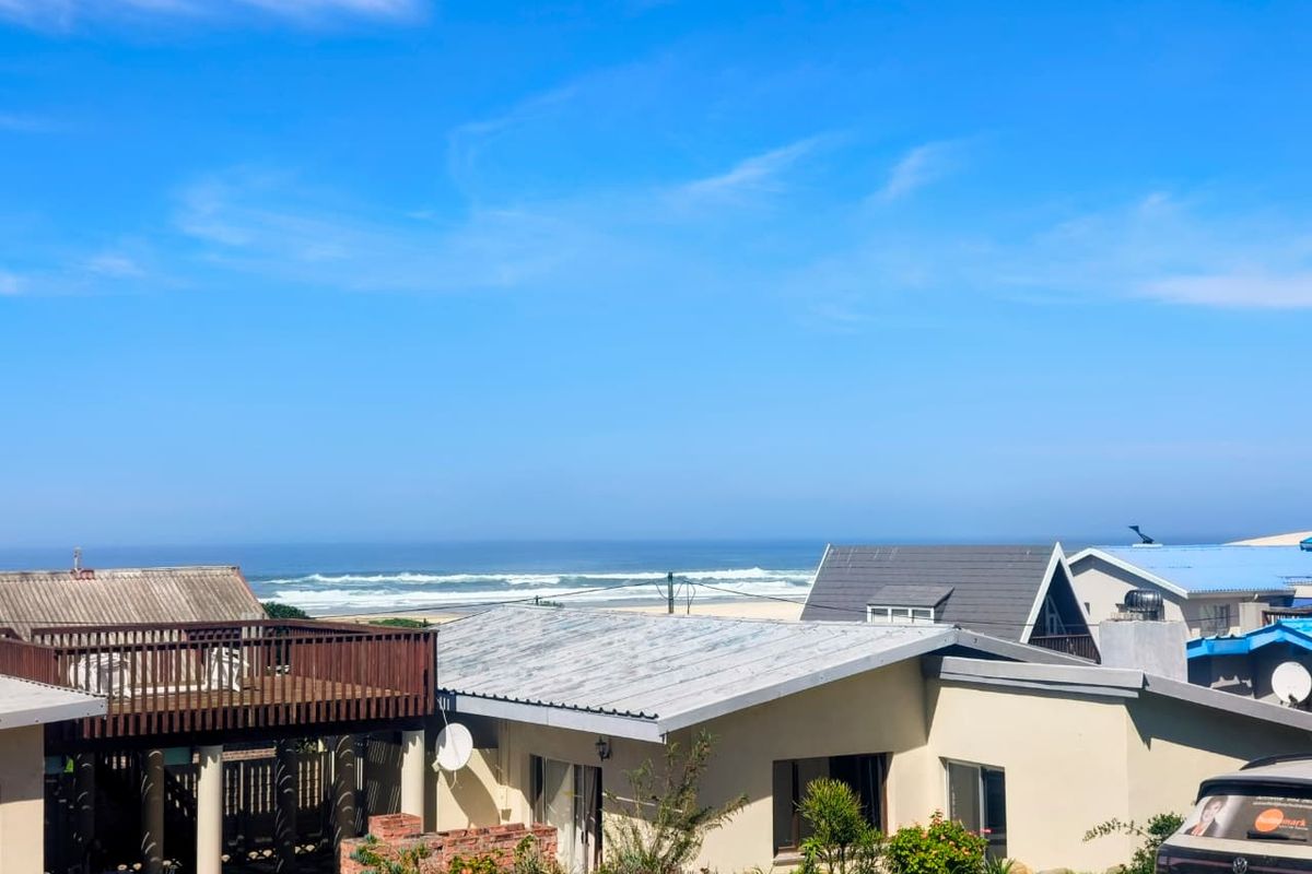 A scenic elevated view overlooking the coastline and ocean, showcasing the property's prime location and surrounding residential neighborhood.