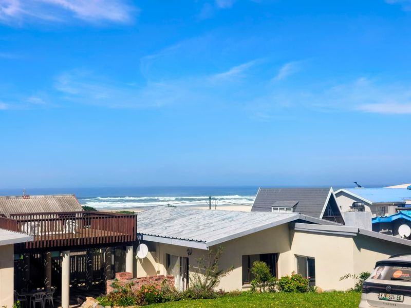 A scenic elevated view overlooking the coastline and ocean, showcasing the property's prime location and surrounding residential neighborhood.