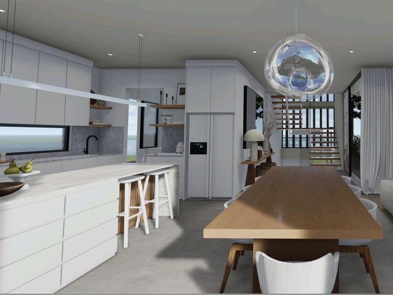 Modern open-plan living area featuring a sleek kitchen with stone island, integrated cabinetry, and seamless flow to the dining and lounge spaces.