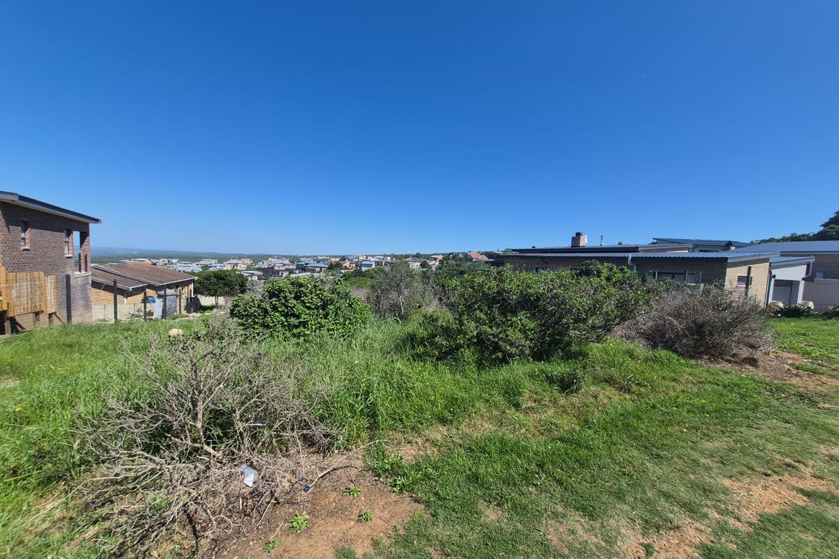 A wide-angle view of the vacant residential land, showcasing the surrounding neighborhood and natural landscape.