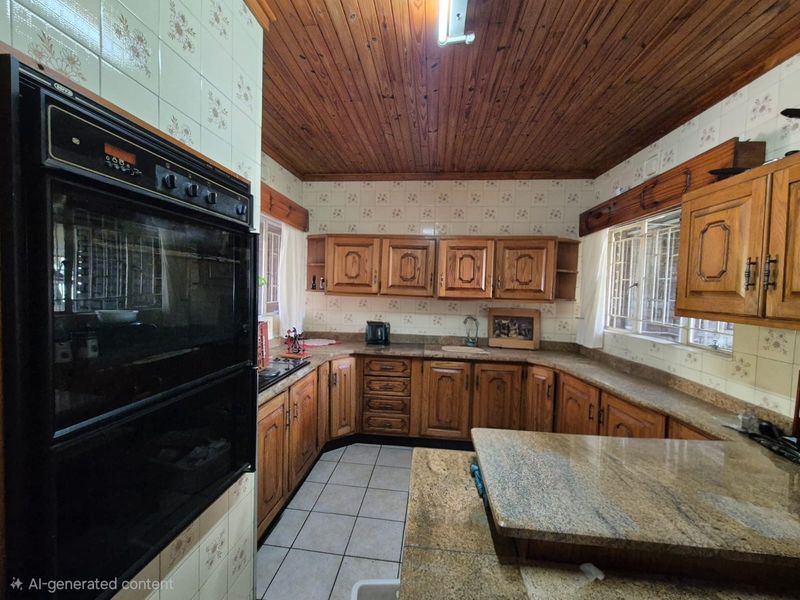 A traditional kitchen featuring wooden cabinetry, granite countertops, and a timber ceiling, offering a classic aesthetic with potential for modern updates.