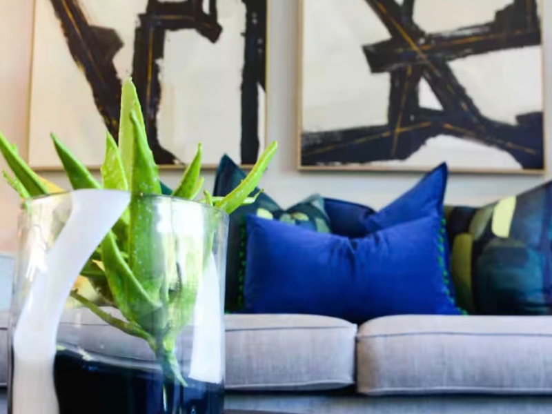 A close-up view of a living room area focusing on decorative elements and seating.