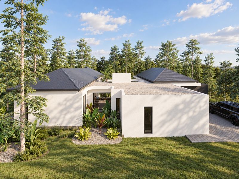 Modern single-story residence featuring a clean stucco facade, dark metal roofing, and a paved driveway set within a lush, landscaped environment.