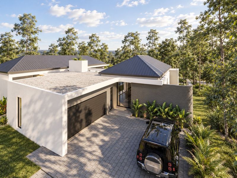 Modern architectural home featuring a paved driveway, double garage, and clean lines, set within a lush, landscaped environment.