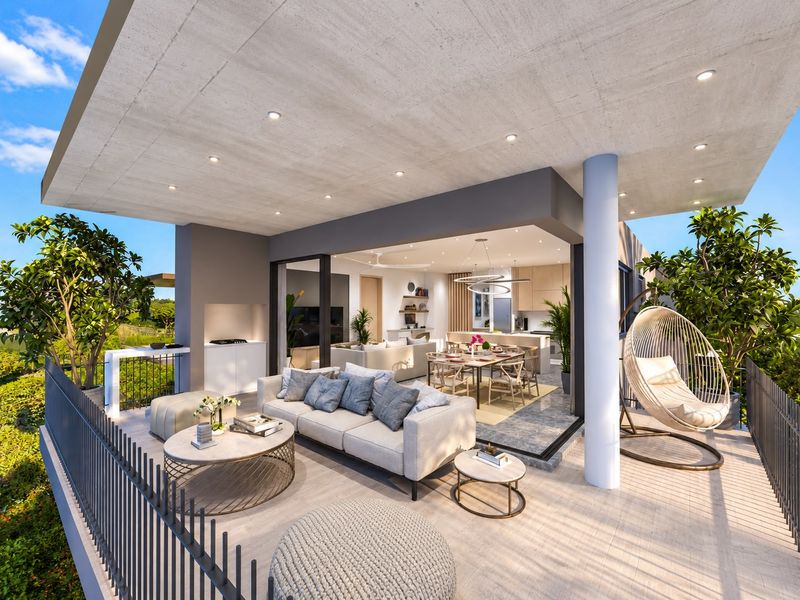 Spacious covered balcony featuring a built-in outdoor kitchen, recessed lighting, and seamless transition to an open-plan interior living and dining area.