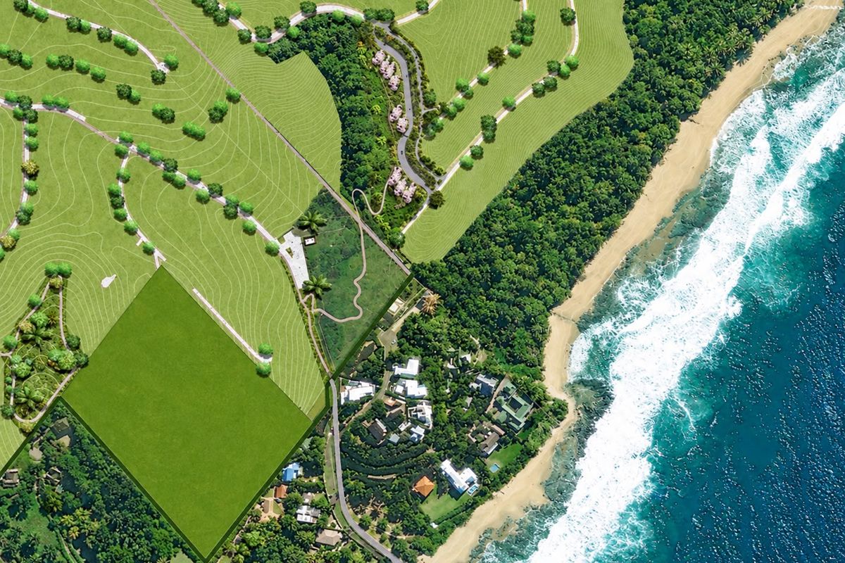 An aerial view of the coastal property development, showcasing the beach frontage, surrounding lush landscape, and site layout.