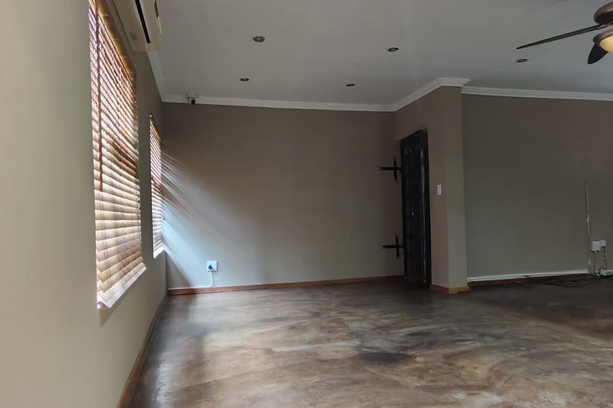 Spacious, empty living area featuring polished concrete floors, recessed lighting, a ceiling fan, and an integrated air conditioning unit.