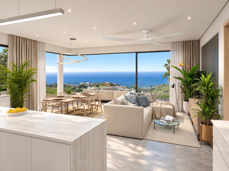 Spacious open-plan living and dining area featuring floor-to-ceiling glass doors with panoramic ocean views and a modern stone-topped kitchen island.