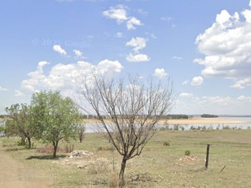 A view of vacant residential land featuring natural vegetation and direct water frontage.