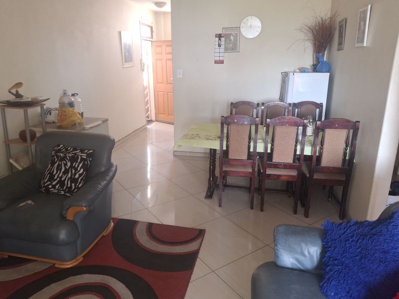 Open plan living and dining area featuring tiled flooring and direct access to the main entrance.