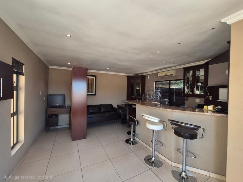 A dedicated bar area featuring a built-in counter with granite top, tiled flooring, and integrated cabinetry, suitable for entertaining.