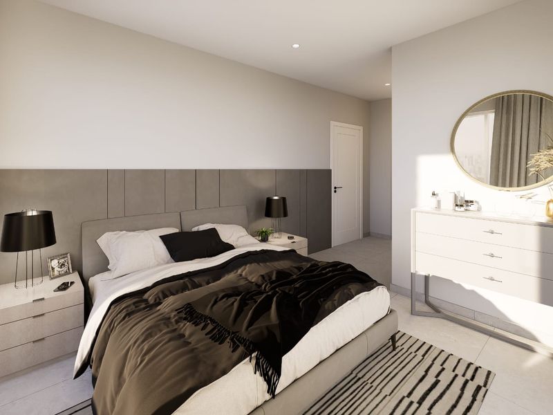 A modern, well-lit bedroom featuring a stylish panelled feature wall, recessed ceiling lighting, and neutral tiled flooring.