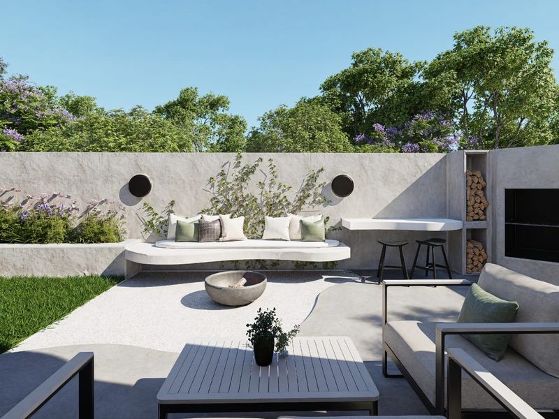 Modern outdoor patio area featuring a built-in concrete bench, integrated fireplace with wood storage, and landscaped garden backdrop.