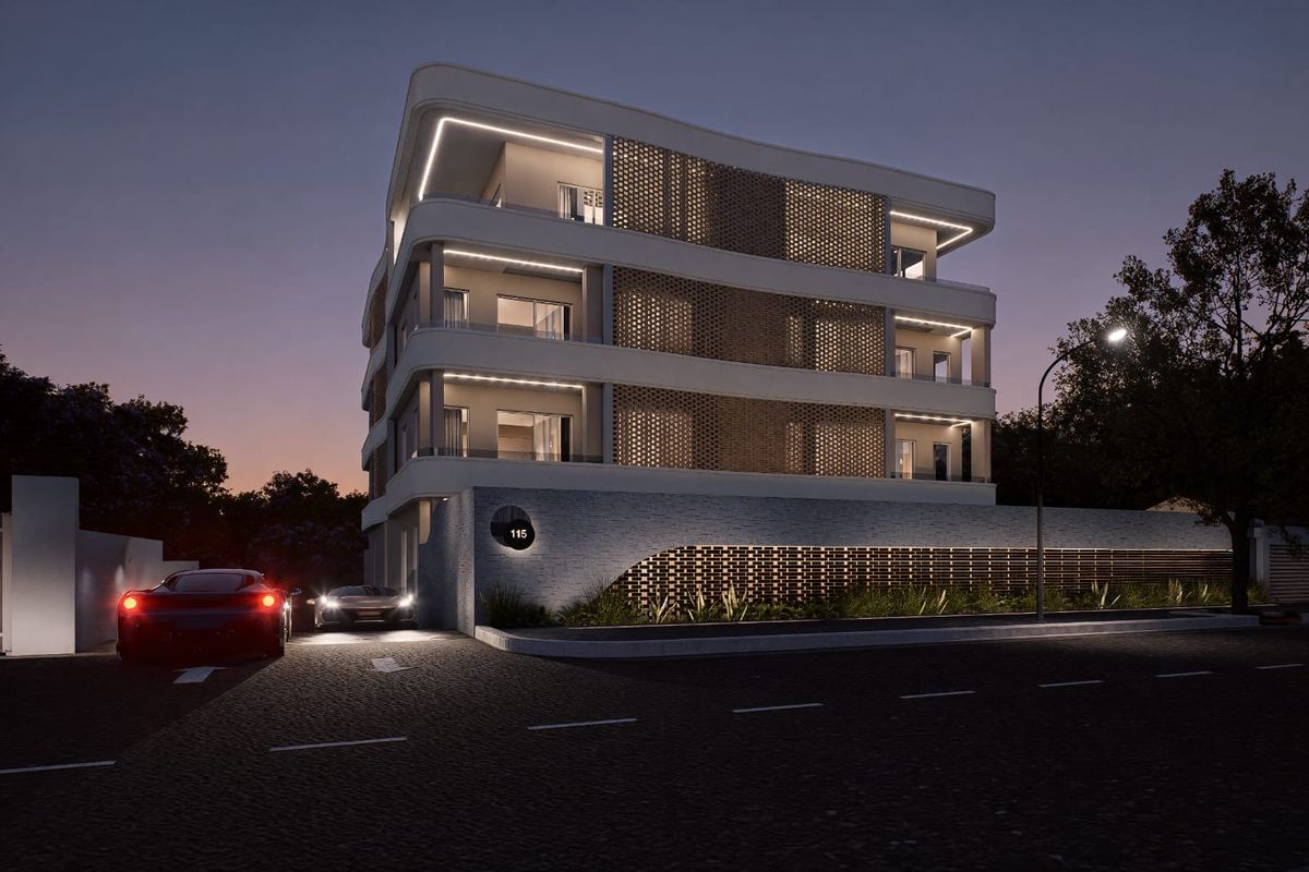 A modern apartment building exterior at dusk, featuring contemporary architectural design, decorative brickwork, and integrated facade lighting.