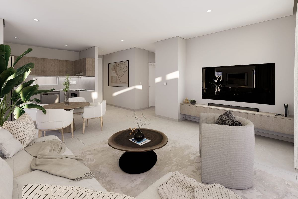 Modern open-plan living area featuring a sleek kitchen, tiled flooring, recessed lighting, and a custom floating media console in a contemporary apartment setting.