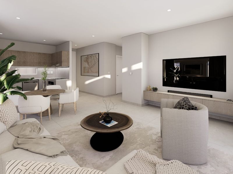 Modern open-plan living area featuring a sleek kitchen, tiled flooring, recessed lighting, and a custom floating media console in a contemporary apartment setting.