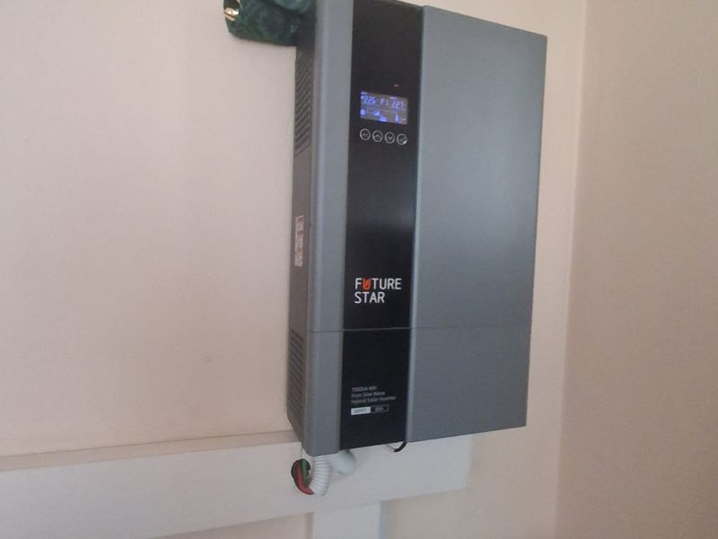 Wall-mounted Future Star hybrid solar inverter unit with associated electrical conduit and circuit breaker infrastructure.