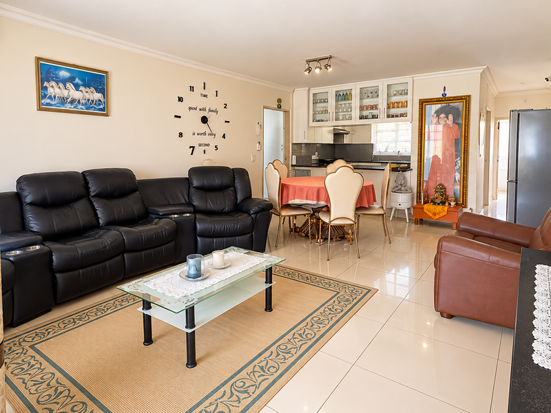 Spacious open-plan living and dining area featuring tiled flooring, integrated kitchen cabinetry, and a split-system air conditioner.