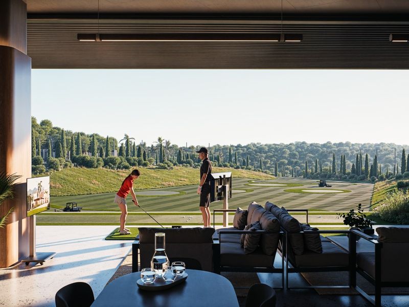 Expansive covered patio featuring seamless indoor-outdoor flow, high-end finishes, and direct views overlooking a manicured golf course.