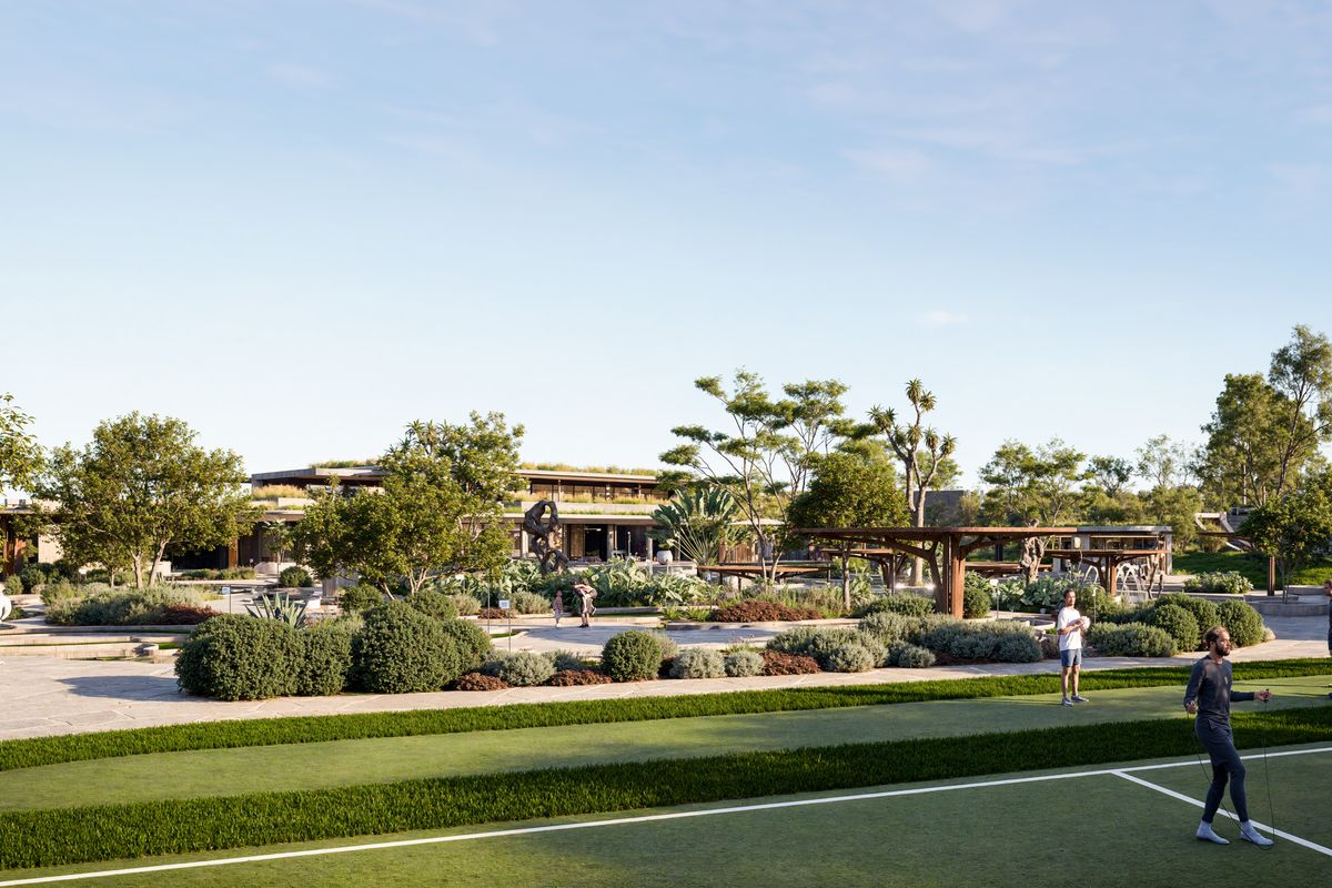 A beautifully landscaped outdoor communal area featuring manicured gardens, paved walkways, and modern pergola structures within a residential estate setting.