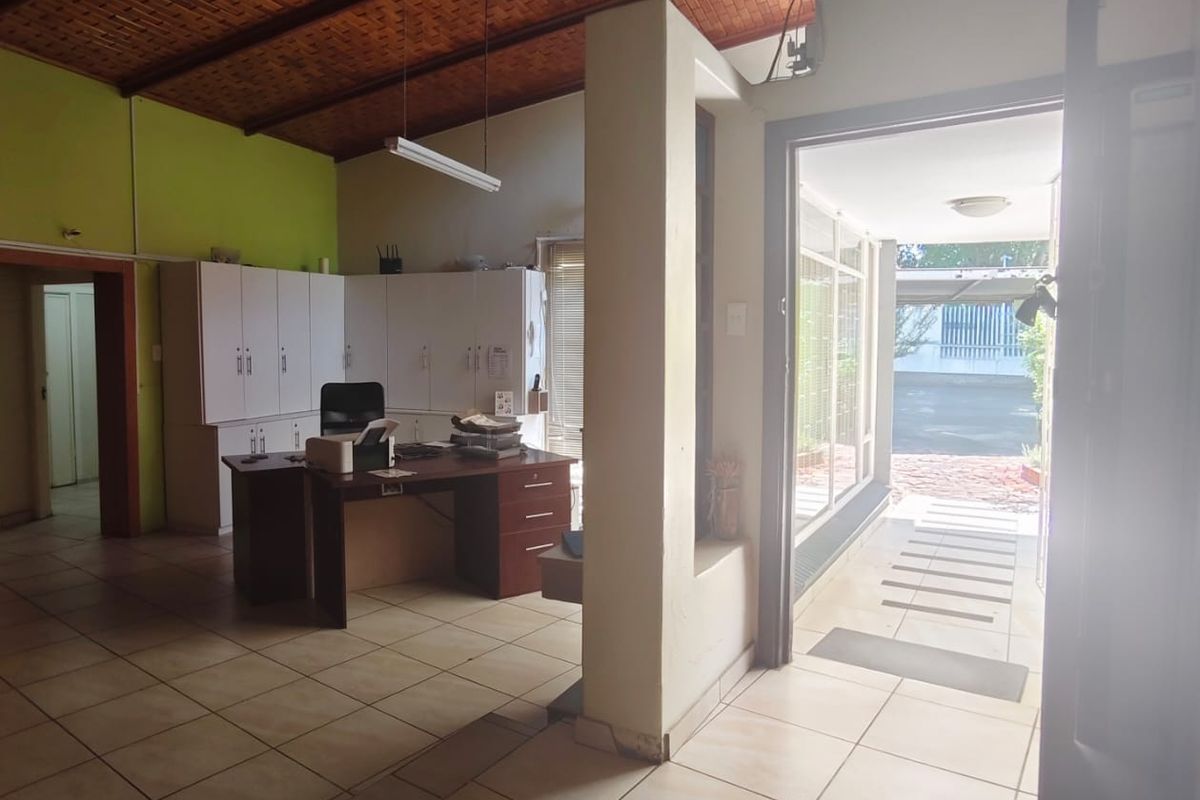 Entrance area featuring tiled flooring, exposed brick ceiling, and built-in cabinetry, providing a functional transition space into the property.