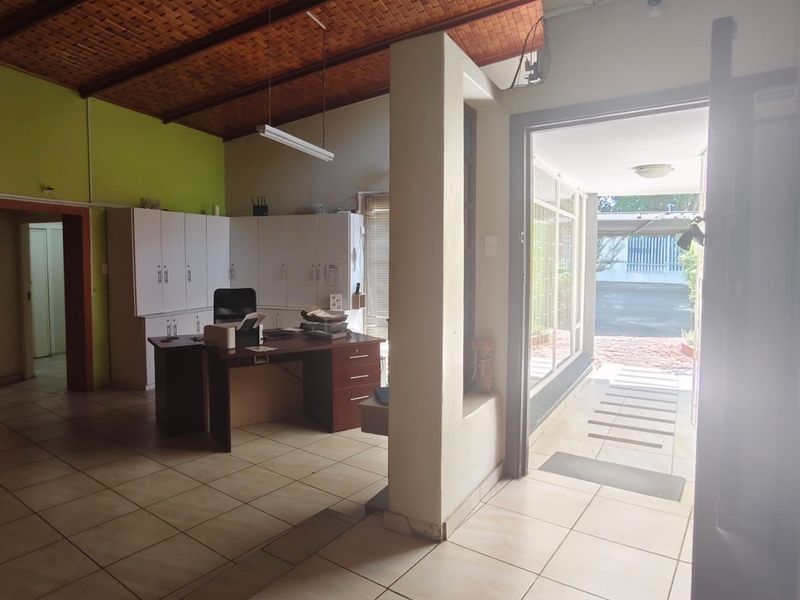 Entrance area featuring tiled flooring, exposed brick ceiling, and built-in cabinetry, providing a functional transition space into the property.