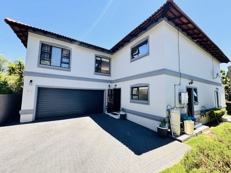 Front elevation of a double-storey house featuring a double garage, paved driveway, and well-maintained exterior finishes.