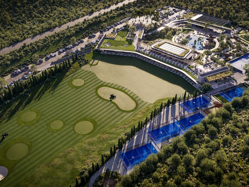 Aerial view of a luxury residential estate featuring a golf course, swimming pool, tennis courts, and extensive landscaped grounds.