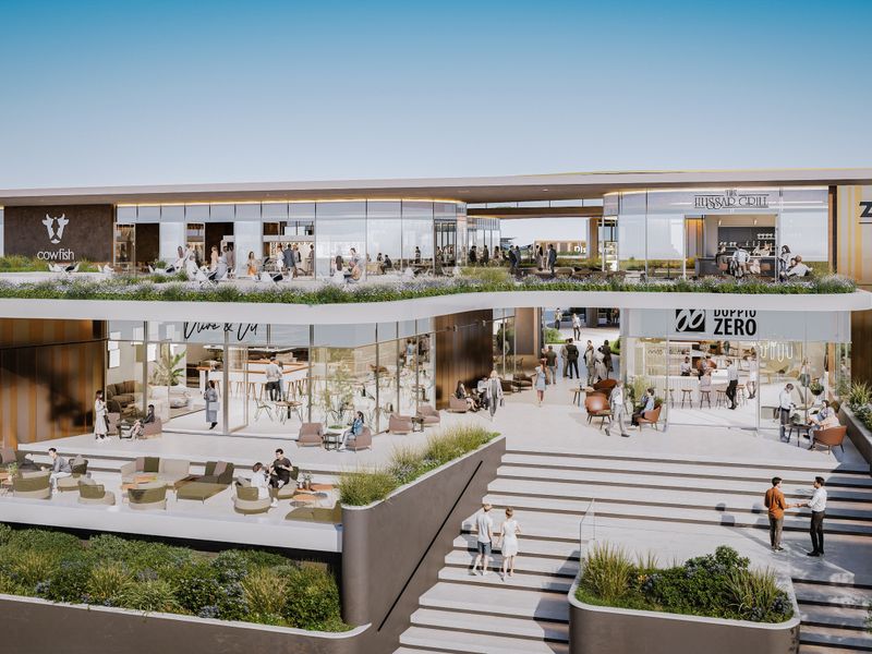 A modern multi-level commercial complex featuring glass facades, landscaped terraces, and prominent signage at Zimbali Square.