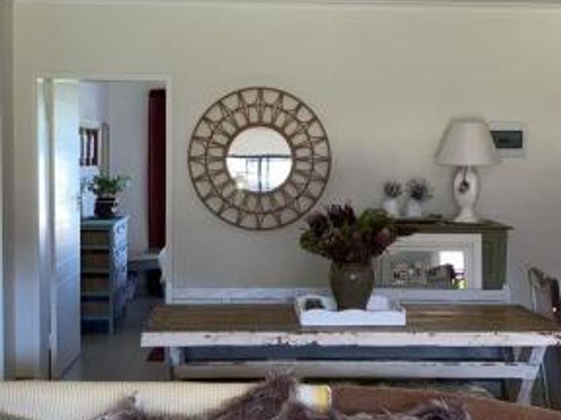 A view of a living area featuring a ceiling-mounted spotlight and an internal doorway leading to an adjacent room.