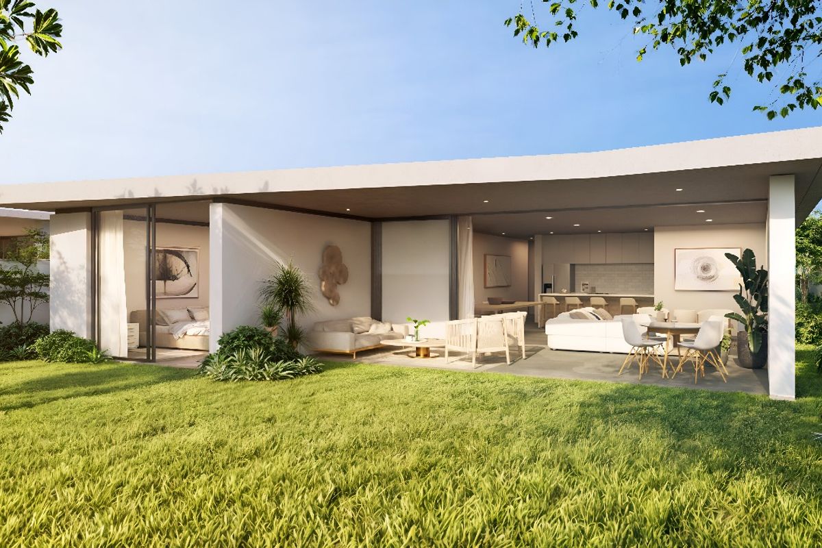A modern residential property featuring a spacious covered patio area seamlessly integrated with an open-plan interior, overlooking a well-maintained garden.