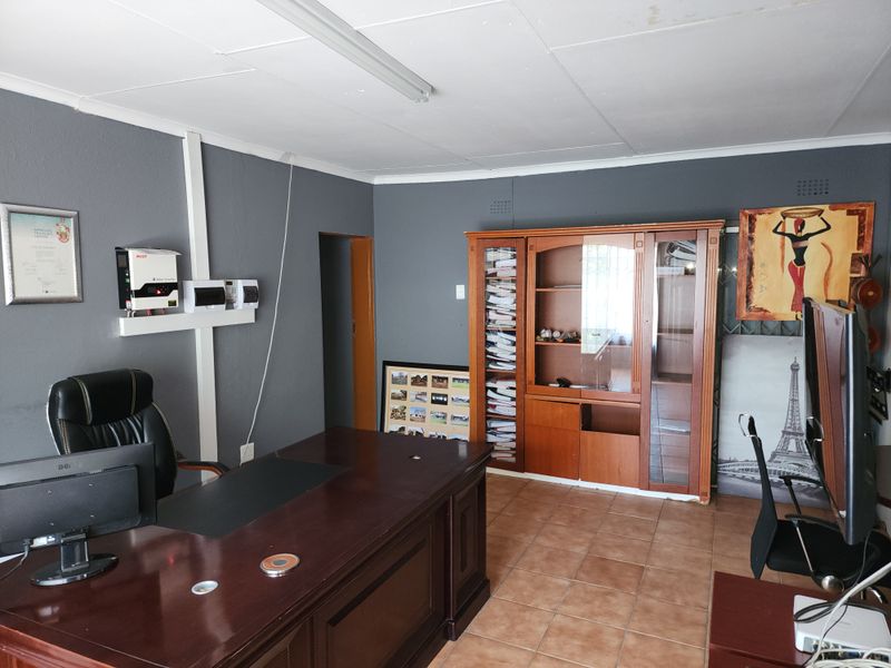 A functional home office space featuring tiled flooring and an installed inverter system, providing a practical area for work or study.