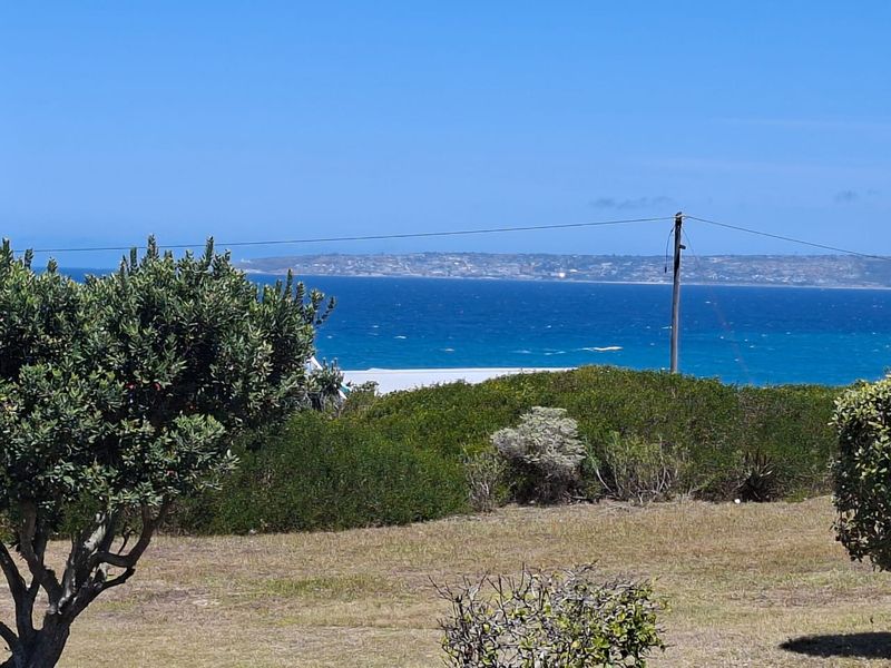 A scenic view of the ocean and coastline from the property grounds.
