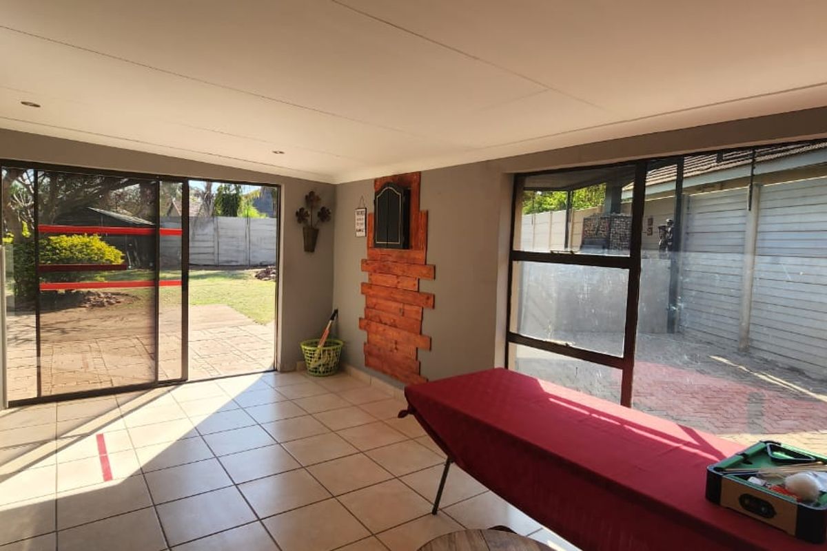Spacious living area featuring large sliding glass doors that provide direct access to the rear garden and patio.