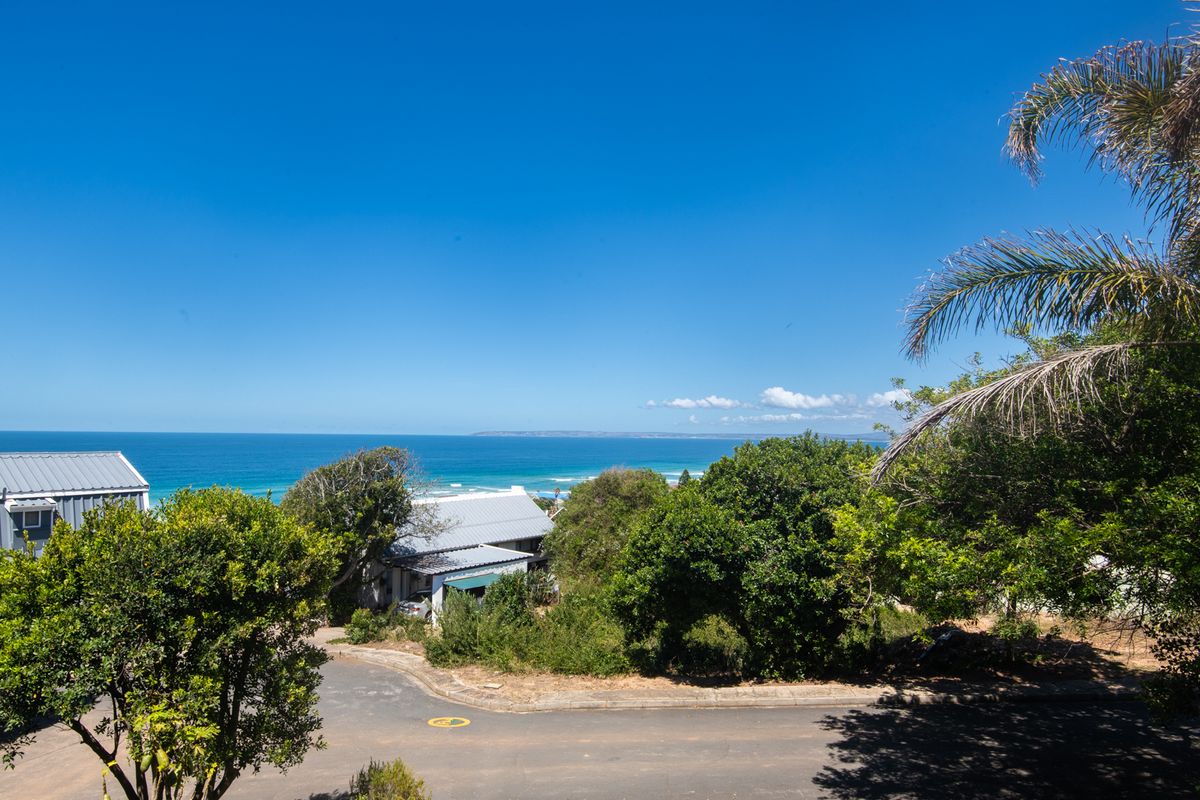 A scenic elevated view overlooking the coastal landscape and ocean, showcasing the property's prime location and natural surroundings.