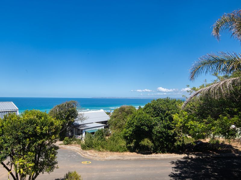A scenic elevated view overlooking the coastal landscape and ocean, showcasing the property's prime location and natural surroundings.