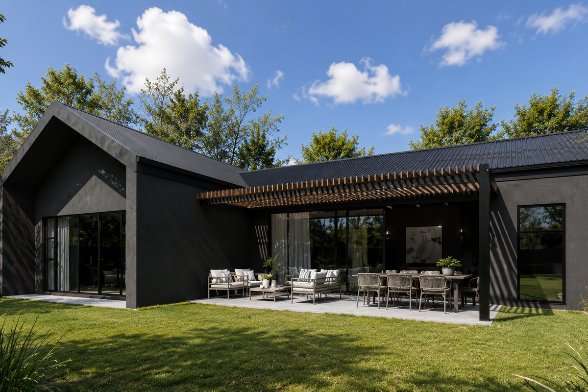 Modern rear exterior view featuring a dark facade, corrugated metal roof, timber pergola, and a spacious concrete patio overlooking a landscaped garden.