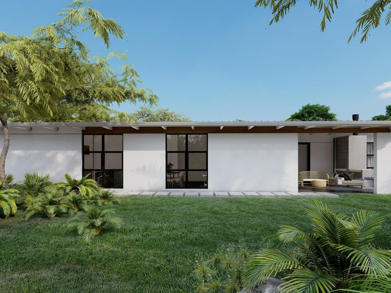 A modern rear exterior view featuring a covered patio, black framed windows, and a well-maintained landscaped garden.
