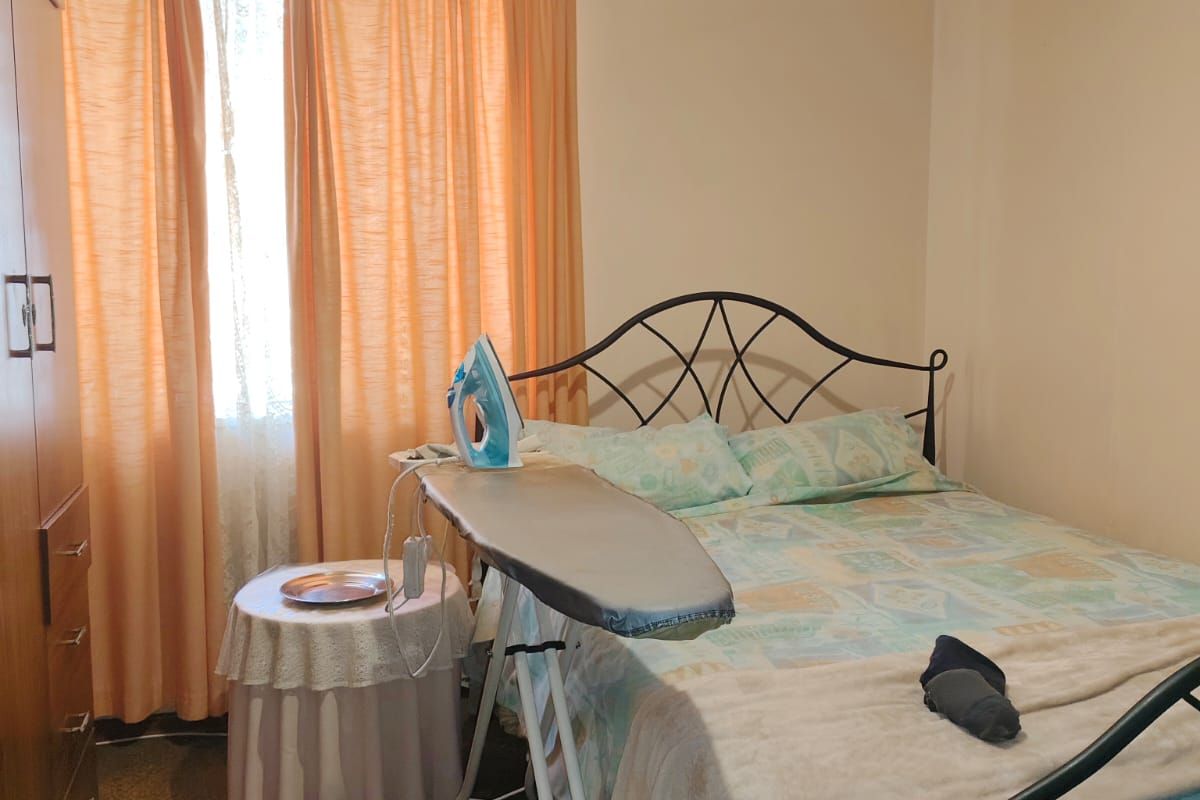 A standard bedroom featuring built-in cabinetry and carpeted flooring, providing a functional living space.